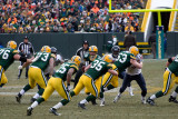 Aaron Rodgers (12) hands the ball off to Ryan Grant (25)