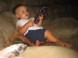 Trsitan relaxing with the remote.JPG