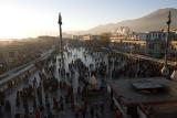 Jokhang square just before sunset, note pilgrims circling the temple or praying, and Potala in the background.