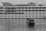 NB Earnest turns into the Pontoon dock with floating hotel in the background