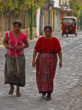 Women Walking Cobblestone Street