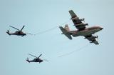 C-130 refuelling two HH-60G Pave Hawks