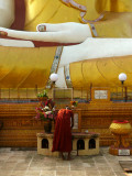Monk with giant buddha Bago.jpg