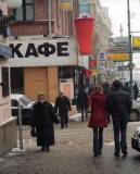 Red cafe sign on Tverskaya Street, Moscow, with girl in red coat