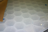Glass over honeycomb form to reduce weight.