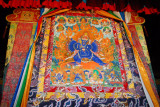 Large thangka hanging in the center of the nunnerys main assemby hall