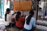 Three girls working on one carpet