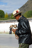 Tibetan man doubling his luck with 2 prayer wheels