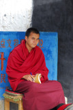 Monk with a book on gate duty