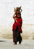 Monk carrying a heavy jug