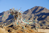 Prayer flags erected on ruins at Chrten (stupa) of Nartang Monastery