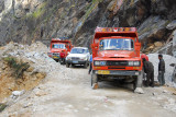 Road crew blocking most of the road with their dump truck