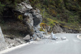 Fresh rock slide partially blocking the newly paved road