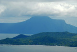 Volcano Island with Mount  Makulots summit in the clouds across Lake Taal