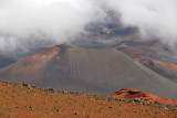 Pu'u o Maui, a cinder cone in the crater of Mount Haleakala, partially obscured by cloud