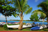 Modern fiberglass outrigger canoes behind the Chamorro Village