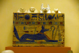 Wooden box painted with Anubis in the form of a jackal containing four canopic jars
