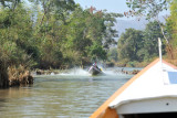 Long boat coming in the other direction over another dam