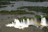 A rainbow in the mist tossed up from the Devils Throat - Iguau Falls aerial