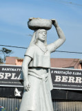 Sculpture of a woman carrying a basket, Ilha do Cabo