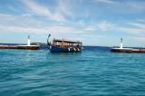 A dhoni enters the harbor on the north shore of Male