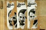 Ripped posters of Iranian President Mahmoud Ahmadinejad