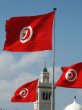 Tunisian flags with the minaret of the Kasbah Mosque