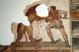 Gladiator (Bellunaire) spears a lion in a Roman amphitheatre