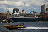 Queen Mary 2 in Sydney Harbour with jetboat foreground