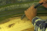 Using a scraping chisel to smooth the area