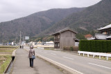 Walking along a windswept road