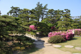 Sculpted trees and flowers beside the stone bridge