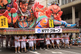 Group of young males pushing a float