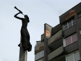 Herald statue and crumbling apartment block