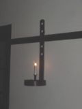 Homes were lit by candles in holders on the walls.  They could be removed & carried, if necessary.