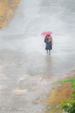 Woman in the Rain with Red Umbrella