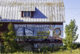 Displayed on a barn next to the Wood Orchid market