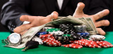poker player with chips and money at casino table