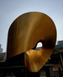 a brass sculpture in a public housing estate