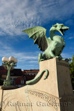 Green copper Dragon statue on concrete pedestal of Dragon Bridge over the Ljubljanica river symbol of Ljubljana Slovenia 