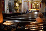 Interior of the St. Nicholas Ljubljana Cathedral Catholic church with votive candles at the back of the church pews Ljubljana Sl