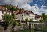 Renovated historic buildings Cankar Quay embankment of the Ljubljanica river canal at Fish Bridge and Castle Hill of Ljubjlana S