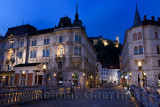 Stritar Street at dawn between Kresija Building and Philip Mansion towards Ljubljana Castle Hill from Triple Bridge in Old Town 