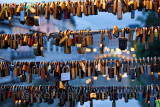 Close up of love locks on Butchers' bridge at dusk with lights of Triple bridge over Ljubljanica river canal in background Ljubl