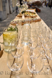 Table on cobblestone Stari street Ljubljana Slovenia with food and glasses for water flavoured with lemon mint and elderberry fl