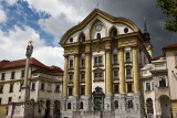 Spot of sun on the Ursuline Church of the Holy Trinity with marble statues of the Holy Trinity column in Ljubljana Slovenia with