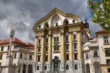 Full sun on the Ursuline Church of the Holy Trinity with marble statues of the Holy Trinity column in Ljubljana Slovenia with da