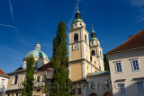 Clock and Bell towers with copper dome of St. Nicholas Catholic church Ljubljana Cathedral from Pogacar Square Ljubljana Sloveni