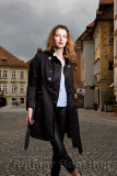 Young attractive woman standing in the cobblestone Upper Square with the Hercules fountain of Old Square in the old town of Ljub