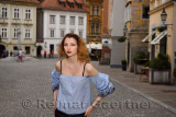 Young attractive woman standing in the cobblestone Upper Square with the Hercules fountain of Old Square in the old town of Ljub